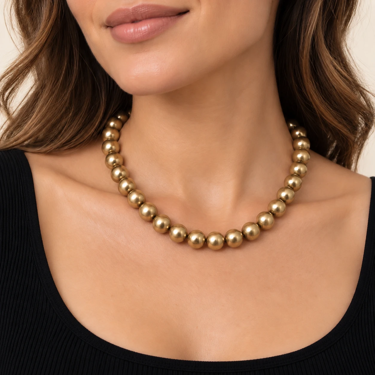 AI styling preview of Gold-Tone Round Bead Necklace with Lobster Clasp worn on a model