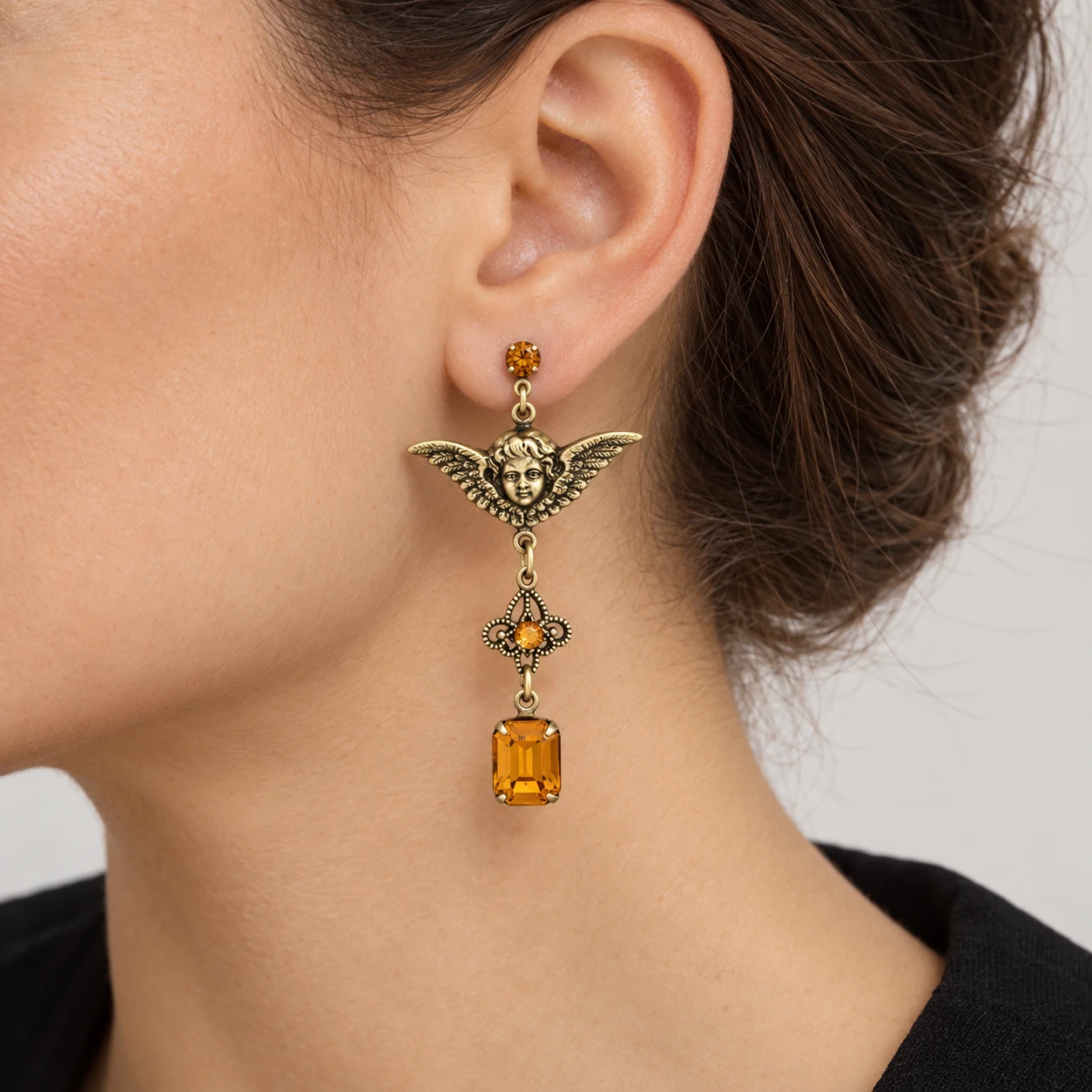 AI styling preview of Topaz-Tone Angel Wing Crystal Earrings worn on a model